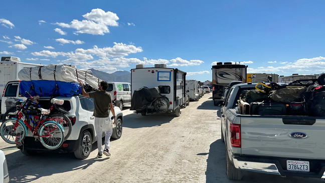Vehicles line up in a several hour wait to leave the Burning Man festival in Black Rock Desert, Nev., Tuesday, Sept. 5, 2023. (AP Photo/Andy Barron)